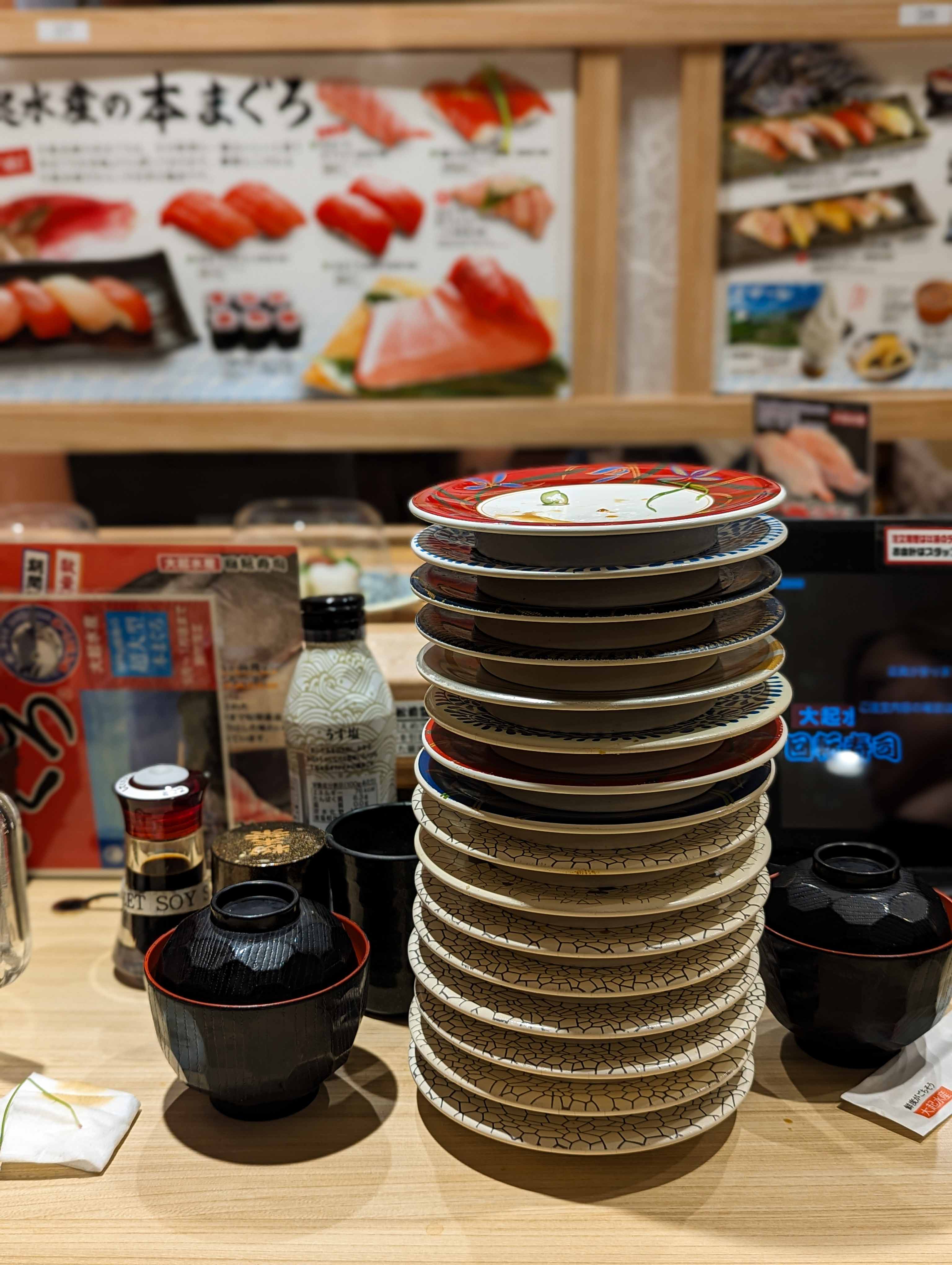 Stack of plates at Daiki suisan kaitenzushi Kyoto tower sand, Kyoto, Japan